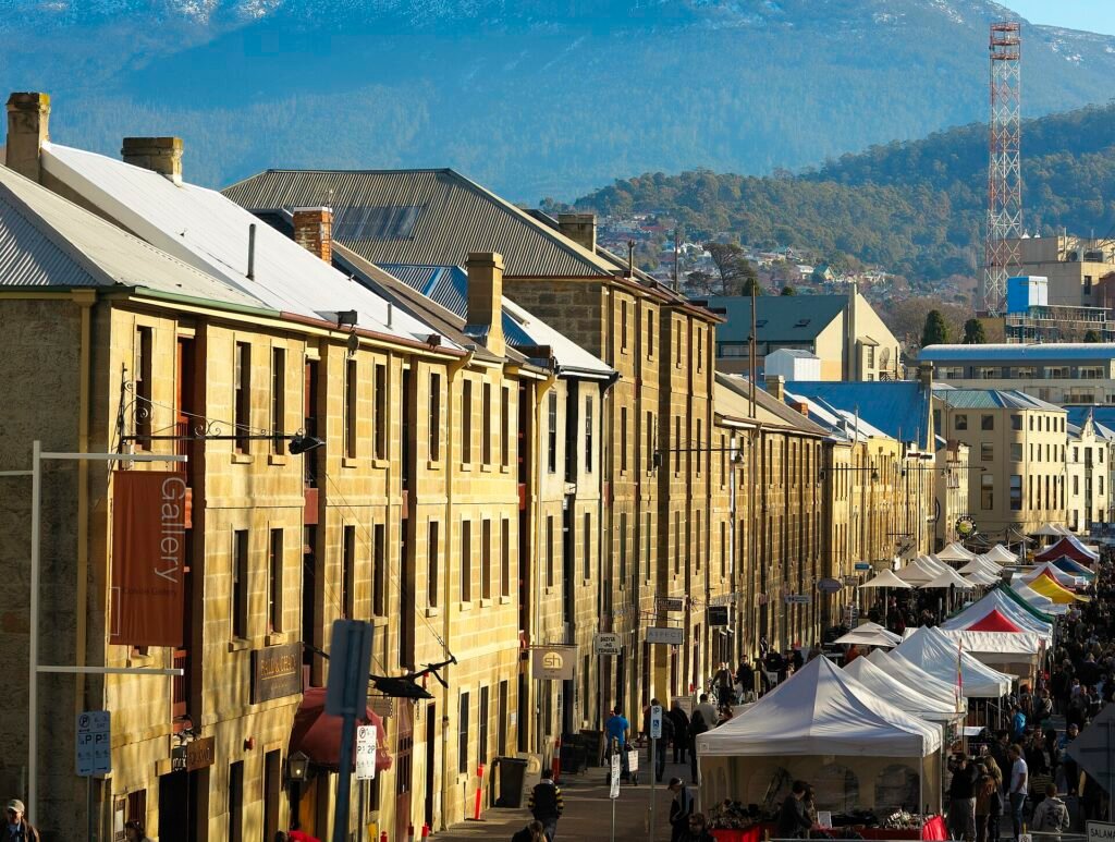 Sandstone warehouses on Salamanca Place in Hobart, with snow-capped Mount Wellington behind