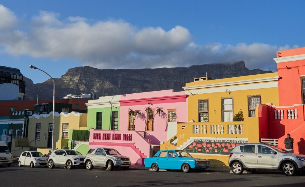 Colorful Bo-Kaap houses in Cape Town with Table Mountain behind them